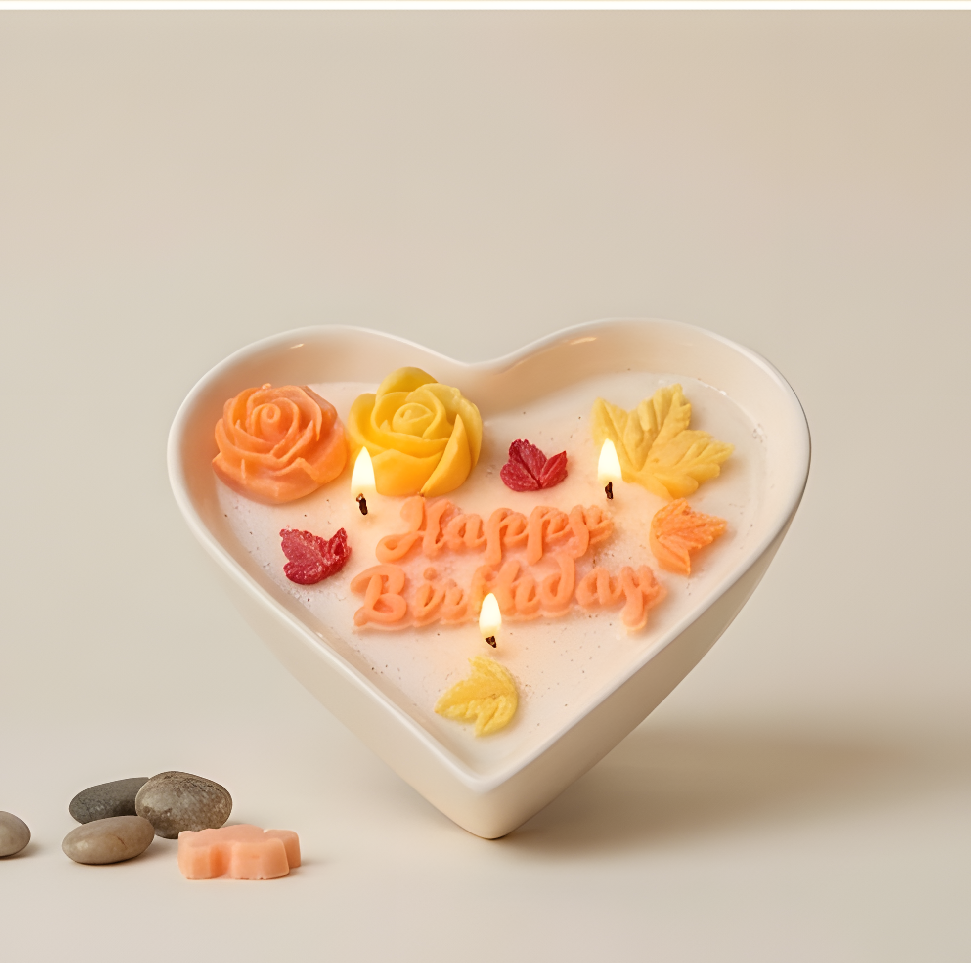 Personalized birthday candle in heart-shaped container with colorful wax decorations and lit wicks.